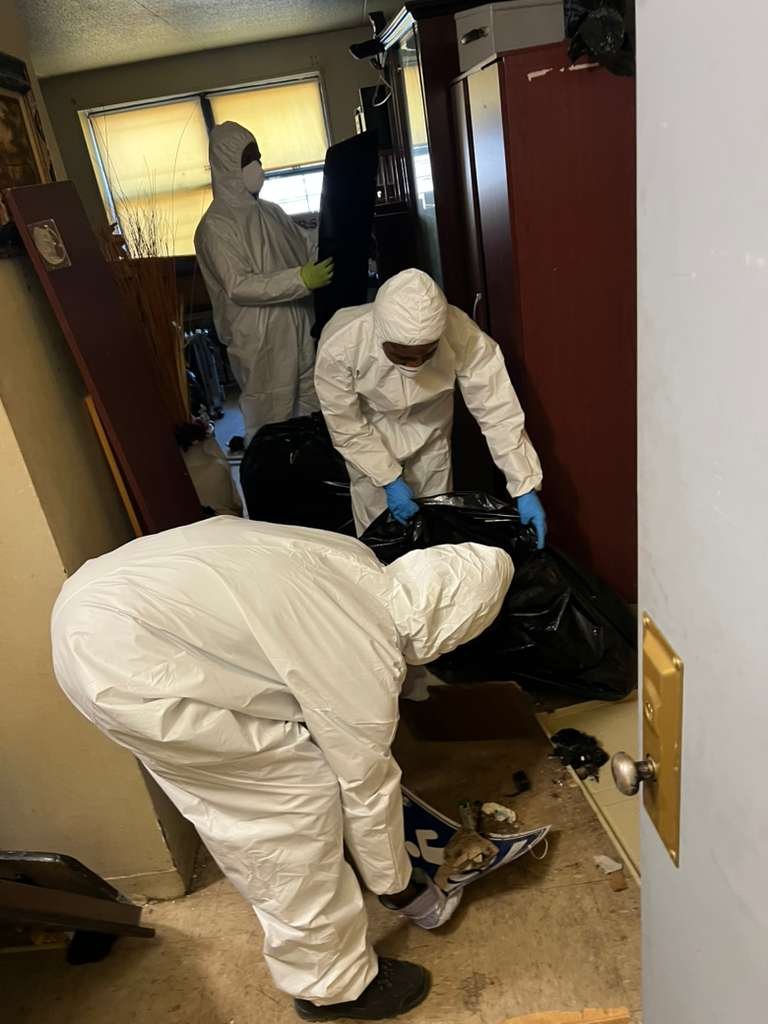 Klean N' Jiffy cleaning team member wiping a kitchen counter in a New York City apartment